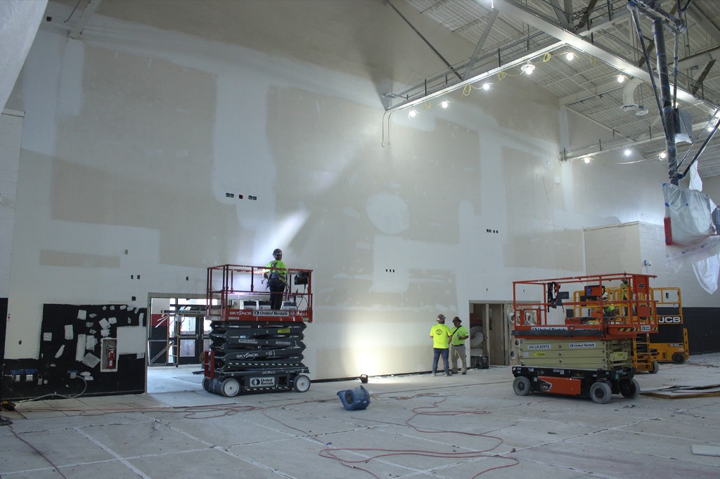 Grassland crews on scissor lifts in a convention hall